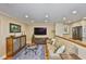 Cozy living room with modern entertainment center and hardwood floors that connect to the kitchen at 5701 Mariner St # 701, Tampa, FL 33609