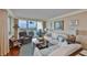 Bright living room with floor-to-ceiling windows and a sliding glass door to a private balcony at 5701 Mariner St # 701, Tampa, FL 33609