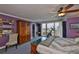 Well lit main bedroom featuring outdoor views from the attached balcony and exercise equipment at 5701 Mariner St # 701, Tampa, FL 33609