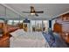 Bright main bedroom boasts a ceiling fan, balcony access, and an open view of the city skyline at 5701 Mariner St # 701, Tampa, FL 33609