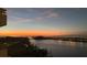 Evening waterfront view with a colorful sunset, landscape and bridge in the distance at 5701 Mariner St # 701, Tampa, FL 33609