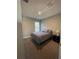 Cozy bedroom featuring carpeted floors, a comfortable bed, and a bedside table with lamp at 5924 Fieldmoor Ct, Palmetto, FL 34221