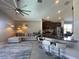 Open-concept living space with a kitchen featuring bar seating, and a comfortable sectional sofa at 5924 Fieldmoor Ct, Palmetto, FL 34221