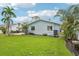 Lush backyard featuring a well-maintained lawn and the rear exterior of the home at 6010 Bayou Grande Ne Blvd, St Petersburg, FL 33703