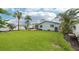 Green backyard with lush green lawn and a back view of the house at 6010 Bayou Grande Ne Blvd, St Petersburg, FL 33703