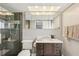 Modern bathroom offers a glass-door shower, a wood vanity, and good lighting at 6010 Bayou Grande Ne Blvd, St Petersburg, FL 33703