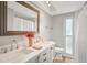 Elegant bathroom with double sinks, neutral walls, and walk-in shower at 6010 Bayou Grande Ne Blvd, St Petersburg, FL 33703