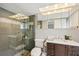 Bathroom features a glass-door shower, gray tile, and a wood vanity at 6010 Bayou Grande Ne Blvd, St Petersburg, FL 33703