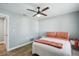 Comfortable bedroom featuring wood flooring and a modern ceiling fan at 6010 Bayou Grande Ne Blvd, St Petersburg, FL 33703