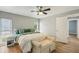 Well-lit bedroom includes bench, wood floors, and view to ensuite bathroom at 6010 Bayou Grande Ne Blvd, St Petersburg, FL 33703