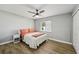 Bright bedroom features a ceiling fan, wood floors, and white nightstand at 6010 Bayou Grande Ne Blvd, St Petersburg, FL 33703