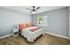 Bedroom with grey walls, ceiling fan, wood floors, and double closet at 6010 Bayou Grande Ne Blvd, St Petersburg, FL 33703