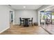 Dining area with wood look tile, a modern table and chairs, and a sliding door to the patio at 6010 Bayou Grande Ne Blvd, St Petersburg, FL 33703