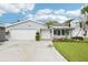 Charming single-story home with a well-maintained front yard, mature palms, and a two-car garage at 6010 Bayou Grande Ne Blvd, St Petersburg, FL 33703
