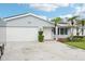 Charming single-story home with a well-maintained front yard, mature palms, and a two-car garage at 6010 Bayou Grande Ne Blvd, St Petersburg, FL 33703