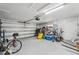 Large garage with a roll up door, storage shelving, and ample space for vehicles at 6010 Bayou Grande Ne Blvd, St Petersburg, FL 33703