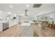 Bright kitchen featuring white cabinets, a marble island, stainless steel appliances, and tile flooring at 6010 Bayou Grande Ne Blvd, St Petersburg, FL 33703