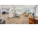 Open concept living room and kitchen with wood floors, a large island and modern finishes at 6010 Bayou Grande Ne Blvd, St Petersburg, FL 33703