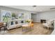 Bright living room featuring a comfortable sofa and seamless flow into the kitchen at 6010 Bayou Grande Ne Blvd, St Petersburg, FL 33703
