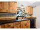 Well-lit kitchen featuring wooden cabinets, modern appliances, and dark countertops at 6109 16Th St, Zephyrhills, FL 33542