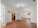 Bright living room with hardwood floors, open archway, recessed lighting, and an adjacent kitchen view at 6109 16Th St, Zephyrhills, FL 33542