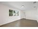 Bright living room featuring a large window and neutral paint, offering a spacious and welcoming atmosphere at 6109 16Th St, Zephyrhills, FL 33542