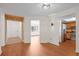 Inviting living area featuring hardwood floors, a stylish light fixture, and neutral paint at 6109 16Th St, Zephyrhills, FL 33542