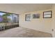 Enclosed outdoor patio with mounted TV and views of backyard at 6109 16Th St, Zephyrhills, FL 33542