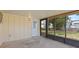 Covered patio showing an external door and a screened-in backyard view with pet door at 6109 16Th St, Zephyrhills, FL 33542