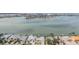Panoramic aerial view showing waterfront homes with private docks on a calm bay with city views in the background at 7092 S Shore S Dr, St Petersburg, FL 33707