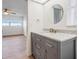 Stylish bathroom featuring a modern gray vanity with luxury white countertops at 7092 S Shore S Dr, St Petersburg, FL 33707