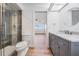 Modern bathroom featuring a glass shower and stylish gray cabinet at 7092 S Shore S Dr, St Petersburg, FL 33707