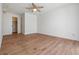 Spacious, bright bedroom featuring wood floors, ceiling fan, closet, and natural light at 7092 S Shore S Dr, St Petersburg, FL 33707