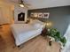 Cozy bedroom with a king-size bed, decorative wall art, and a bedside table with plants at 7092 S Shore S Dr, St Petersburg, FL 33707