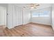 Bright bedroom features wood floors, ceiling fan, and ample closet space at 7092 S Shore S Dr, St Petersburg, FL 33707