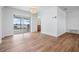 Open dining area features sleek floors, a modern light fixture, and a view of the waterfront through sliding glass doors at 7092 S Shore S Dr, St Petersburg, FL 33707