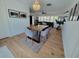 Dining room boasts a wooden table, gray chairs, and a vibrant rug, complemented by bright natural light at 7092 S Shore S Dr, St Petersburg, FL 33707
