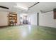 Spacious garage with laundry area, utility sink, shelving for storage, and plenty of room for parking at 7092 S Shore S Dr, St Petersburg, FL 33707