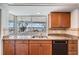 Beautiful kitchen featuring wood cabinets, granite countertops, and a window view of the water at 7092 S Shore S Dr, St Petersburg, FL 33707