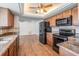 Modern kitchen featuring stainless steel appliances, wood cabinets, and granite countertops at 7092 S Shore S Dr, St Petersburg, FL 33707