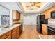 Modern kitchen with wood cabinets, granite countertops, and stainless steel appliances at 7092 S Shore S Dr, St Petersburg, FL 33707