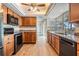 Well-equipped kitchen with wood cabinets, granite countertops, and stainless steel appliances at 7092 S Shore S Dr, St Petersburg, FL 33707