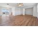 Large living area with sleek floors, a modern light fixture, and a stunning view through sliding glass doors to the water at 7092 S Shore S Dr, St Petersburg, FL 33707