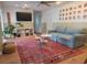 Cozy living room with a large rug, comfortable seating, and a modern entertainment center at 7092 S Shore S Dr, St Petersburg, FL 33707