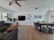 Bright living room with modern decor, wooden floors, and comfortable seating with a decorative ceiling fan at 7092 S Shore S Dr, St Petersburg, FL 33707