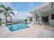 Outdoor living space featuring a private pool, waterfront views, and patio seating area at 7092 S Shore S Dr, St Petersburg, FL 33707