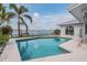 Inviting backyard pool, surrounded by lush landscaping and a view of the water at 7092 S Shore S Dr, St Petersburg, FL 33707