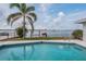 Relaxing pool area with palm trees and scenic waterfront views, perfect for outdoor enjoyment at 7092 S Shore S Dr, St Petersburg, FL 33707