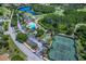 Overhead view of community amenities including a pool, tennis courts, and scenic landscaping at 7253 Cleopatra Dr, Land O Lakes, FL 34637