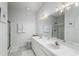 Bright bathroom with dual sinks, large mirror, walk-in shower, and white cabinets at 7253 Cleopatra Dr, Land O Lakes, FL 34637